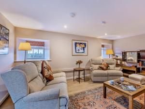 a living room with two couches and a coffee table at 1 Bed in Alnwick oc-95776 in Chillingham