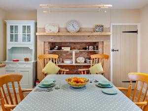 a kitchen with a table with a bowl of fruit on it at 1 Bed in Alnwick oc-95776 in Chillingham
