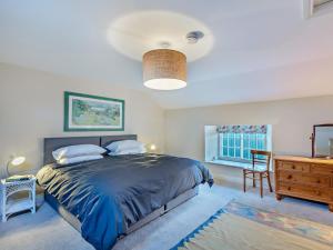 a bedroom with a large bed and a dresser at 1 Bed in Alnwick oc-95776 in Chillingham