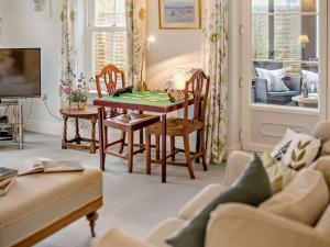 a living room with a table and chairs at 2 Bed in Dorchester oc-59666 in Long Bredy