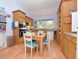 a kitchen with a wooden table and chairs in it at 2 Bed in Dorchester oc-59666 in Long Bredy +21 photos