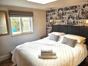 a bedroom with a large bed with two towels on it at 2 Bed in York oc-81551 in Welburn