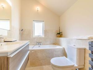 a bathroom with a tub and a toilet and a sink at 2 Bed in York oc-81551 in Welburn +14 photos