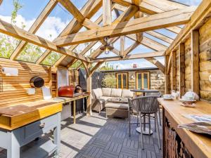 an outdoor kitchen and living room with a wooden ceiling at 2 Bed in York oc-81551 in Welburn