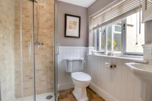 a bathroom with a toilet and a glass shower at 5 Bed in Bramfield oc-sftmh in Bramfield +25 photos