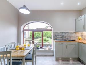 a kitchen with a table and chairs and a window at 2 Bed in Toft Hill oc-80003 in High Etherley +11 photos