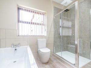 a white bathroom with a toilet and a shower at 2 Bed in Toft Hill oc-80003 in High Etherley