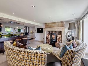 a living room with two couches and a fireplace at 5 Bed in Otley oc-95414 in Fewston