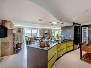 a kitchen with yellow cabinets and a living room at 5 Bed in Otley oc-95414 in Fewston