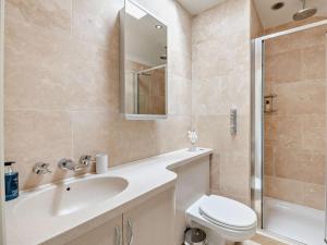 a bathroom with a sink and a toilet and a shower at 5 Bed in Otley oc-95414 in Fewston +52 photos