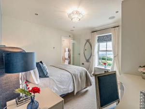 a bedroom with a bed and a table with a lamp at 5 Bed in Otley oc-95414 in Fewston