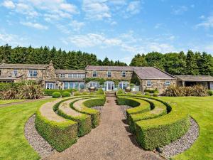 an estate with hedges in front of a building at 5 Bed in Otley oc-95414 in Fewston