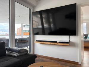 a living room with a flat screen tv on a wall at Apartment Seeboden in Seeboden