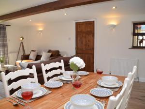 a dining room table with plates and wine glasses at 2 Bed in Chew Magna oc-56550 in Stowey