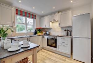 a kitchen with white cabinets and a counter top at 3 Bed in Braunton oc-salar in Georgeham