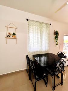 a dining room with a black table and chairs at A La Mer - Solis 3 in Varca