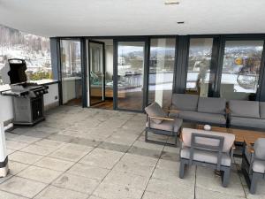 a living room with chairs and a table at Apartment Seeboden in Seeboden
