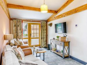 a living room with a couch and a table at 2 Bed in Ripon oc-85510 in Masham