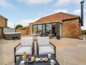 a patio with two chairs and a table at 2 Bed in Northallerton oc-83398 in Brompton