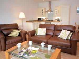 a living room with two brown leather couches and a table at 2 Bed in Chew Magna oc-chela in Stowey +5 photos