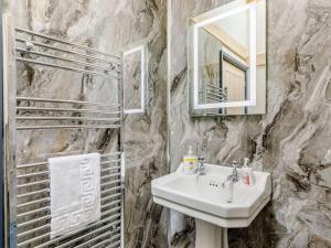 a bathroom with a sink and a mirror at 1 Bed in Ripon oc-85511 in Masham