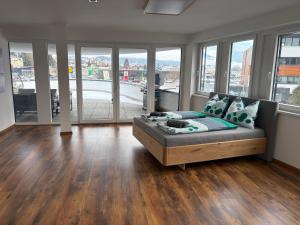 a living room with a couch and some windows at Apartment Seeboden in Seeboden