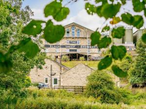 a building with a train on it in the distance at 1 Bed in Ripon oc-85511 in Masham