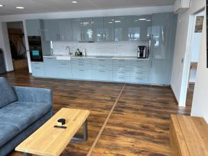 a living room with a couch and a table at Apartment Seeboden in Seeboden +19 photos