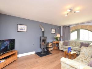 a living room with a couch and a fireplace at 2 Bed in Consett oc-smidc in Lanchester