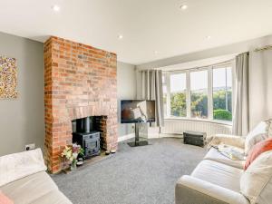 a living room with a brick fireplace and a tv at 2 Bed in Bradford oc-75164 in Thornton