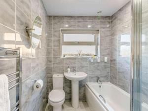a bathroom with a toilet and a sink and a tub at 2 Bed in Bradford oc-75164 in Thornton +18 photos