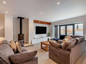 a living room with two couches and a flat screen tv at 3 Bed in York oc-93897 in Tollerton