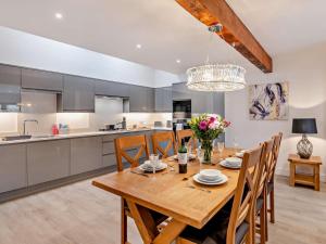 a kitchen and dining room with a wooden table and chairs at 3 Bed in York oc-93897 in Tollerton
