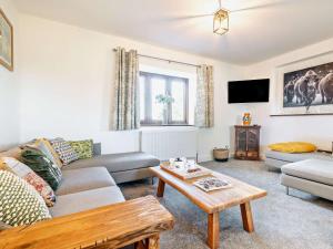 a living room with a couch and a table at 2 Bed in Taunton oc-93581 in Norton Fitzwarren