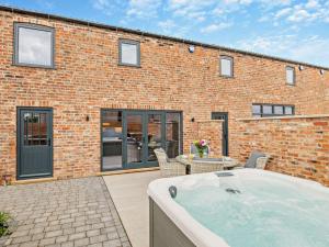 a hot tub in front of a brick building at 3 Bed in York oc-93897 in Tollerton