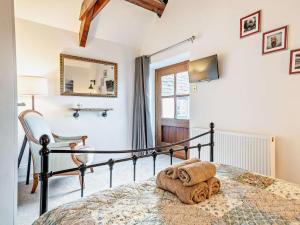 a bedroom with a bed and a chair and a mirror at 2 Bed in Taunton oc-93581 in Norton Fitzwarren +13 photos