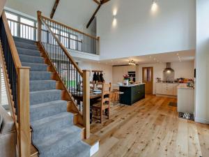 a kitchen and dining room with a staircase in a house at 4 Bed in Brough oc-93496 in Brough