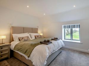 a bedroom with a large bed and a window at 4 Bed in Brough oc-93496 in Brough