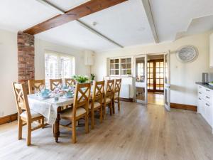 a kitchen and dining room with a table and chairs at 5 Bed in York oc-77267 in Green Hammerton