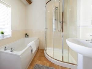 a bathroom with a shower and a tub and a sink at 5 Bed in York oc-77267 in Green Hammerton +23 photos