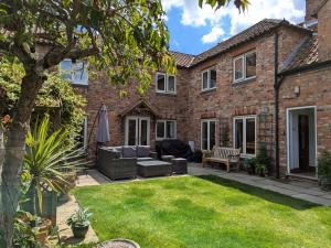 an exterior view of a brick house with a lawn at 5 Bed in York oc-77267 in Green Hammerton