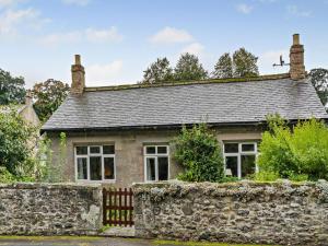 an old stone house with a stone wall at 3 Bed in Cornhill -on- Tweed oc-76374 in Carham