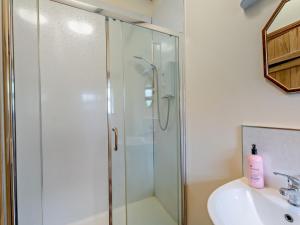 a shower with a glass door next to a sink at 3 Bed in Cornhill -on- Tweed oc-76374 in Carham +18 photos