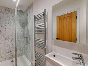 a bathroom with a tub and a sink and a shower at 3 Bed in York oc-93898 in Tollerton +19 photos