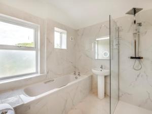 a white bathroom with a tub and a sink at 7 Bed in Bridlington oc-90787 in Bridlington +33 photos