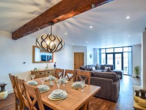 a dining room and living room with a wooden table at 3 Bed in York oc-93896 in Tollerton