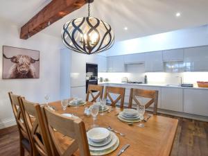 a kitchen and dining room with a wooden table and a chandelier at 3 Bed in York oc-93896 in Tollerton