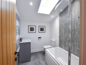 a bathroom with a tub and a toilet and a shower at 3 Bed in York oc-93896 in Tollerton +14 photos