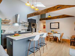 a kitchen with a large island with bar stools at 2 Bed in Axbridge oc-91358 in Loxton
