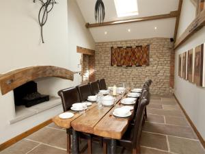 a dining room with a wooden table and chairs at 4 Bed in Slingsby oc-g0146 in Hovingham
